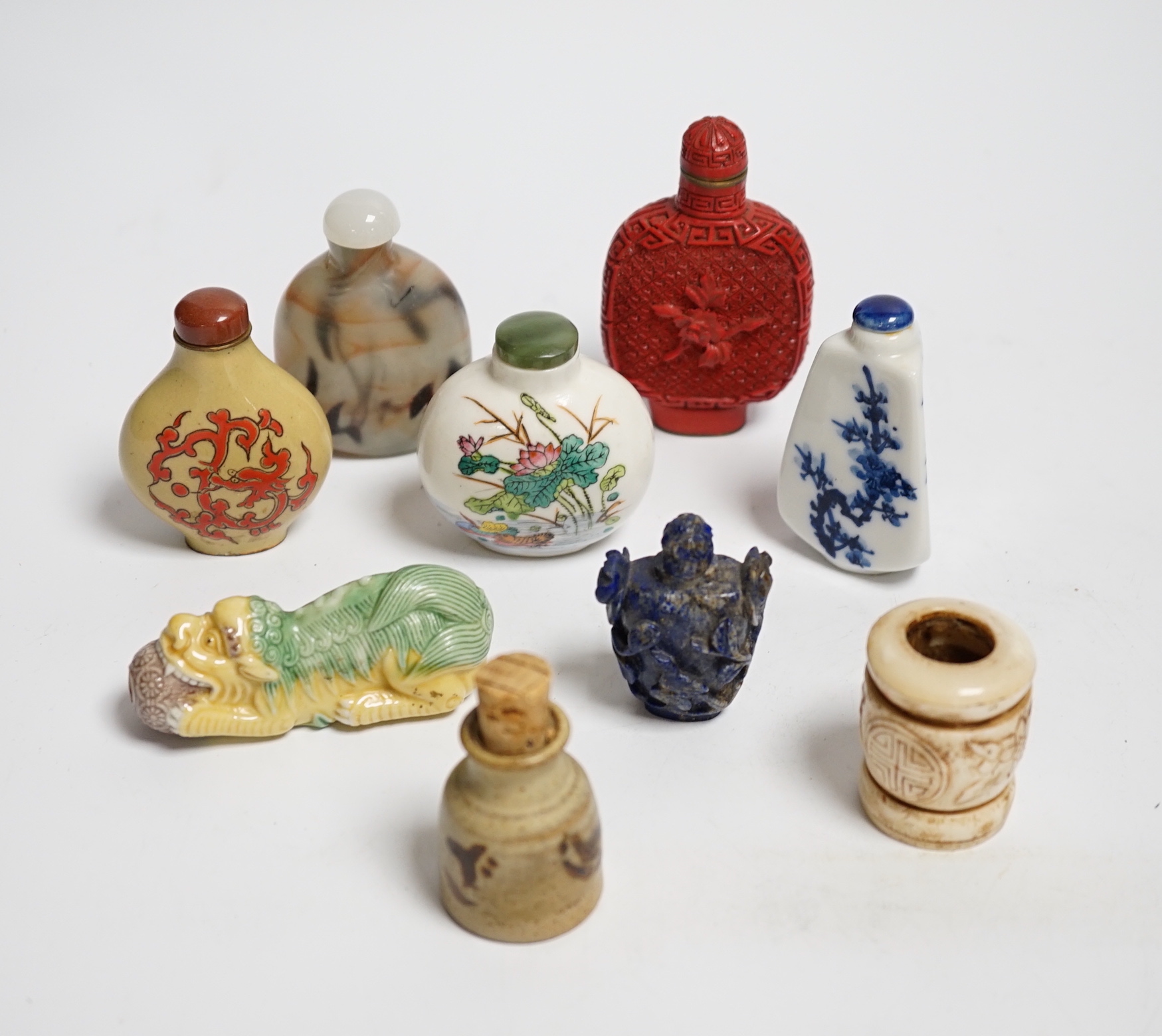 Seven various snuff bottles including simulated cinnabar lacquer, lapis lazuli, ceramic etc. together with a pottery vessel and another bone (9)